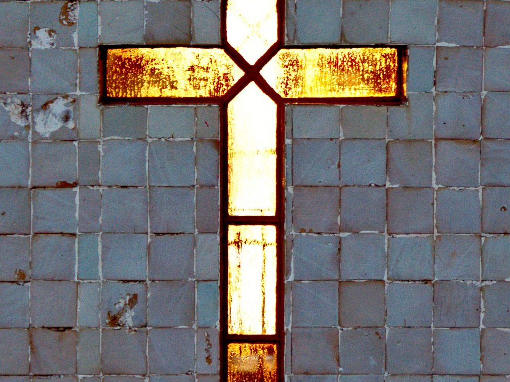 Cross by the Farol Ponta do Arnel The cross by the Farol Ponta do Arnel awakened by the sun.
